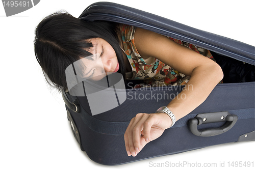 Image of woman in luggage checking time