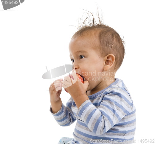 Image of cute boy eating an apple