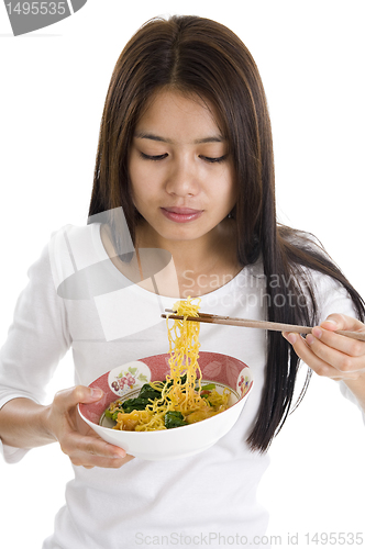 Image of asian woman eating with chop sticks