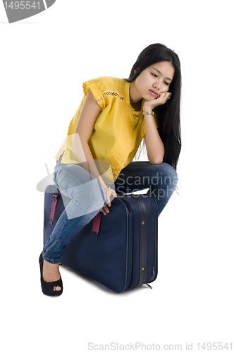 Image of pretty woman sitting on a bag