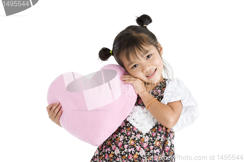 Image of girl with heart shaped pillow