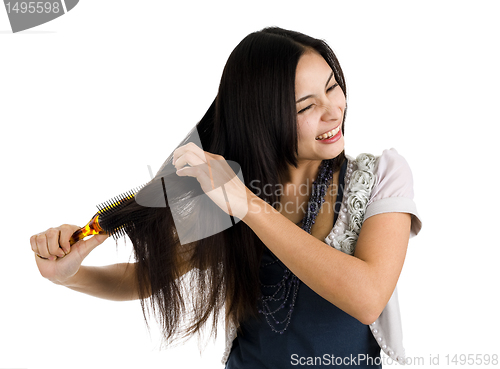 Image of woman brushing her hair