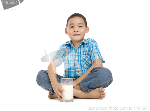 Image of boy sitting with a glass of milk