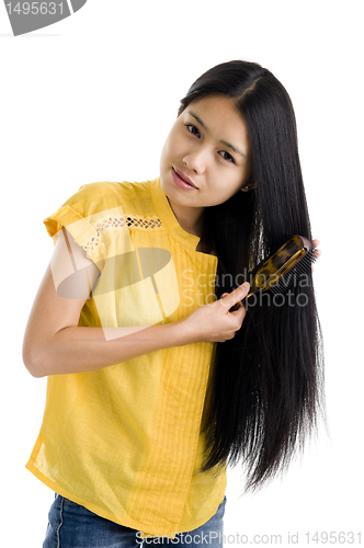 Image of woman brushing her hair
