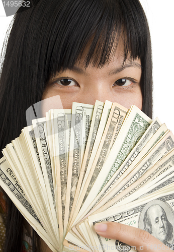 Image of woman's face behind money