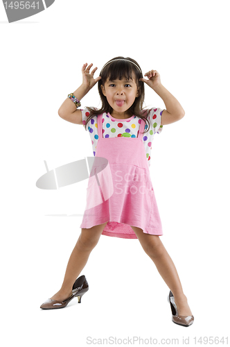 Image of girl with oversized shoes sticking tongue out