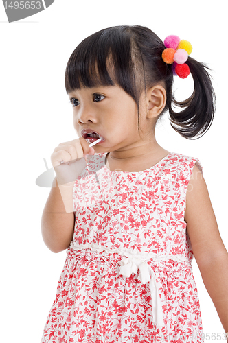 Image of cute little girl with a lollipop 