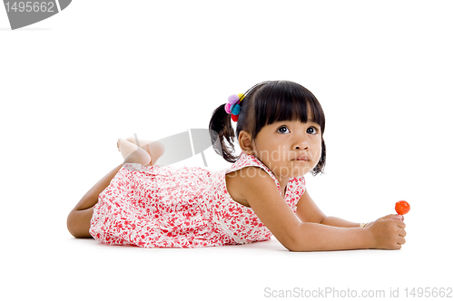 Image of cute little girl with a lollipop