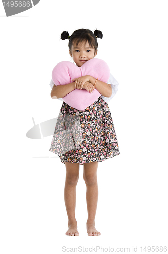 Image of girl with heart shaped pillow