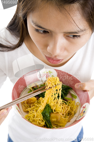 Image of asian woman eating with chop sticks