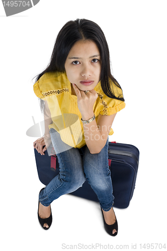 Image of pretty woman sitting on a bag