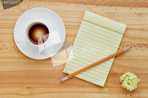 Image of empty coffee cup and notepad