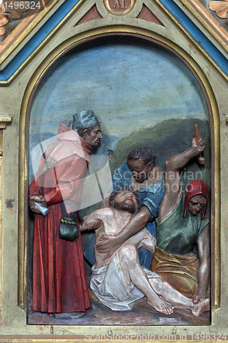 Image of 11th Stations of the Cross, Crucifixion: Jesus is nailed to the cross