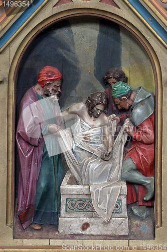 Image of 14th Stations of the Cross, Jesus is laid in the tomb and covered in incense