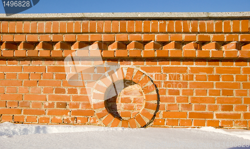 Image of Red brick wall fragment details in winter.