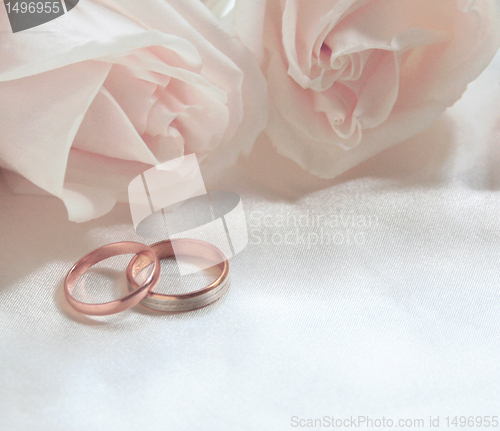 Image of Wedding rings and roses as background 