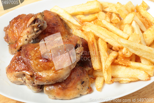 Image of Roast chicken thighs and fries high angle