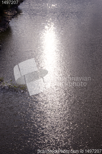 Image of Background of ripple lake water and sun reflections.