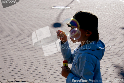 Image of Kid blowing soap bubbles 