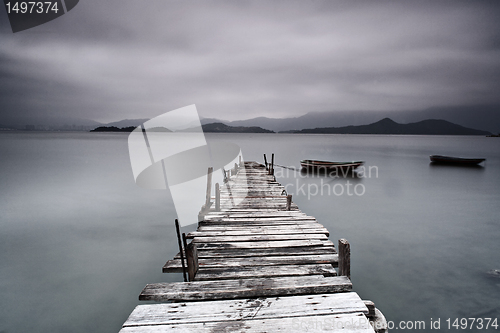 Image of pier and boat, low saturation