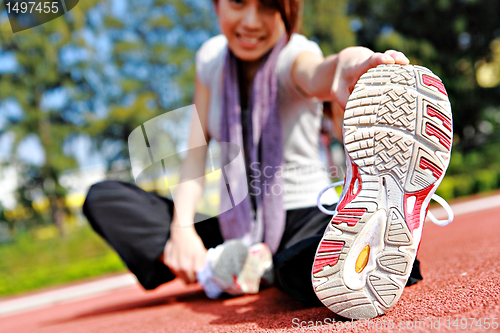 Image of sporty asian girl doing stretching exercise