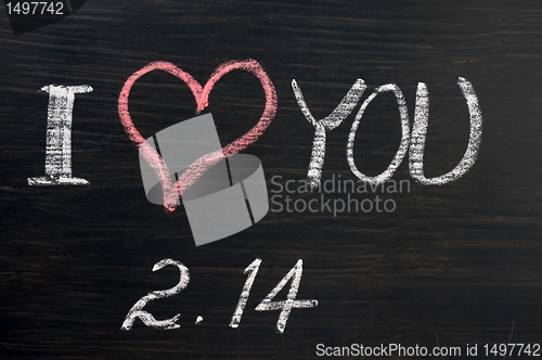 Image of Love with valentine 's date drawn on a chalkboard