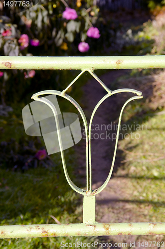 Image of Steel balcony railing decor and garden fragment.