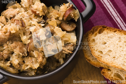 Image of traditional polish sauerkraut (bigos) with mushrooms and plums f
