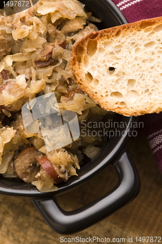 Image of traditional polish sauerkraut (bigos) with mushrooms and plums f