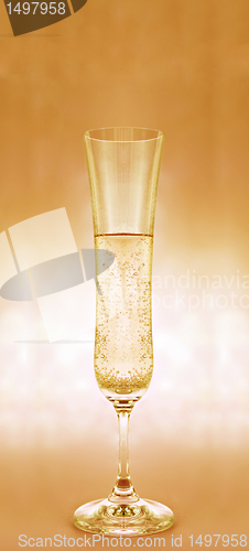 Image of a glass  of champagne on yellow background