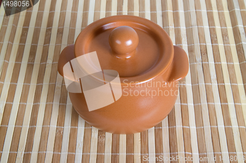 Image of Ceramic pot on the striped mat