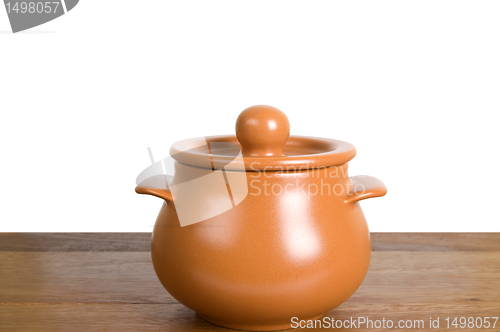 Image of Kitchen clay pot on the wooden board