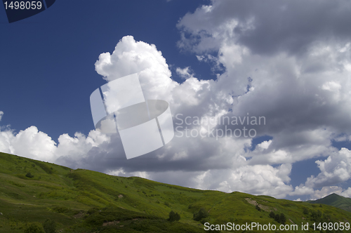 Image of Green hill and blue sky with clouds