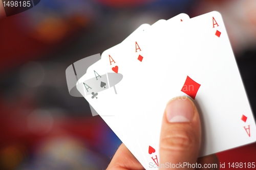 Image of hand holding four aces