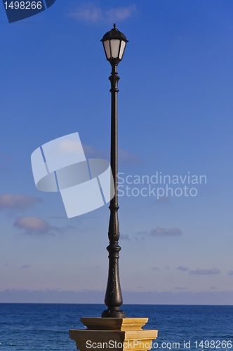 Image of street lamp, sea and sky