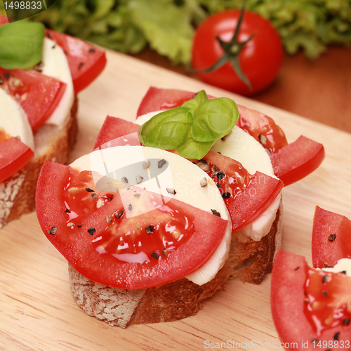 Image of Fingerfood with mozzarella cheese and tomatos