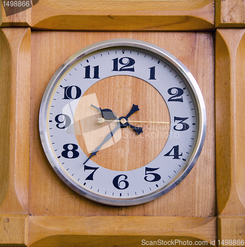 Image of Clock in wooden box showing twentyseven past nine.