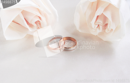 Image of Wedding rings and roses as background 