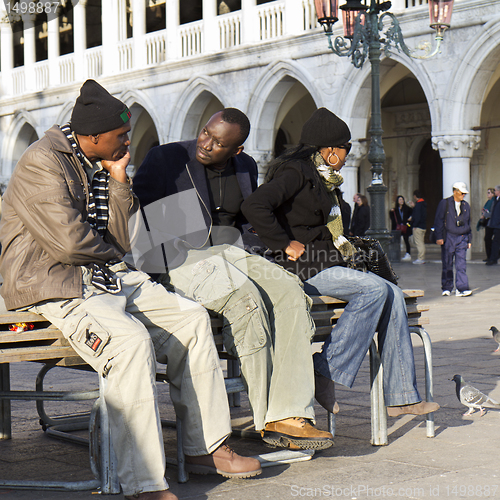 Image of Tourists resting on a bench