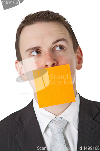 Image of Businessman with a blank  adhesive note over his mouth
