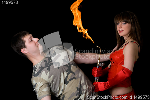 Image of Young woman with a gas torch and scared man. Isolated