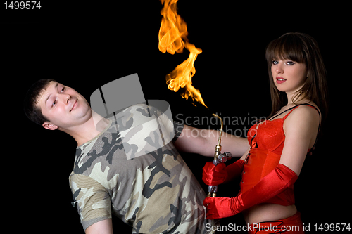 Image of Young woman with a gas torch and scared man