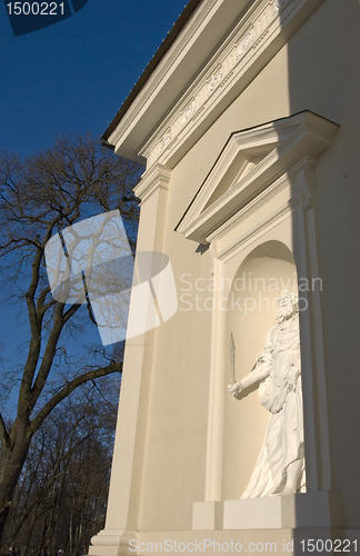 Image of Holy statue holding sword in hand in cathedral arch.