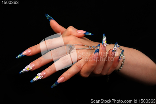 Image of Human fingers with long fingernail and beautiful manicure isolated on black