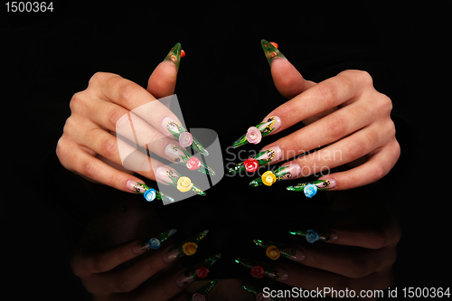 Image of Human fingers with long fingernail and beautiful manicure isolated on black