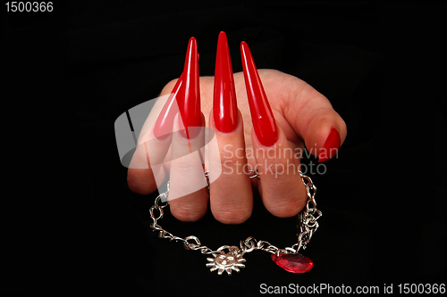 Image of Human fingers with long fingernail and beautiful manicure isolated on black