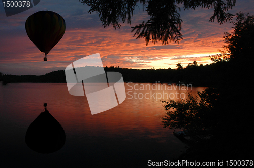 Image of Hot-Air Balloon over Lake at Sunset Sunrise