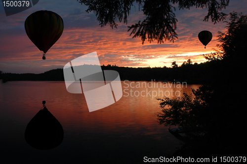 Image of Hot-Air Balloons over Lake at Sunset Sunrise