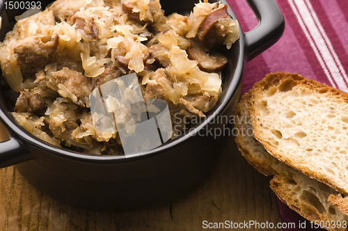 Image of traditional polish sauerkraut (bigos) with mushrooms and plums f