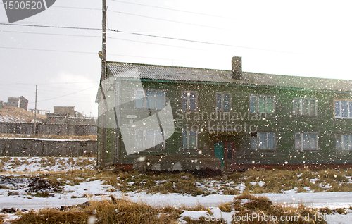 Image of Wooden cottage covered with snow